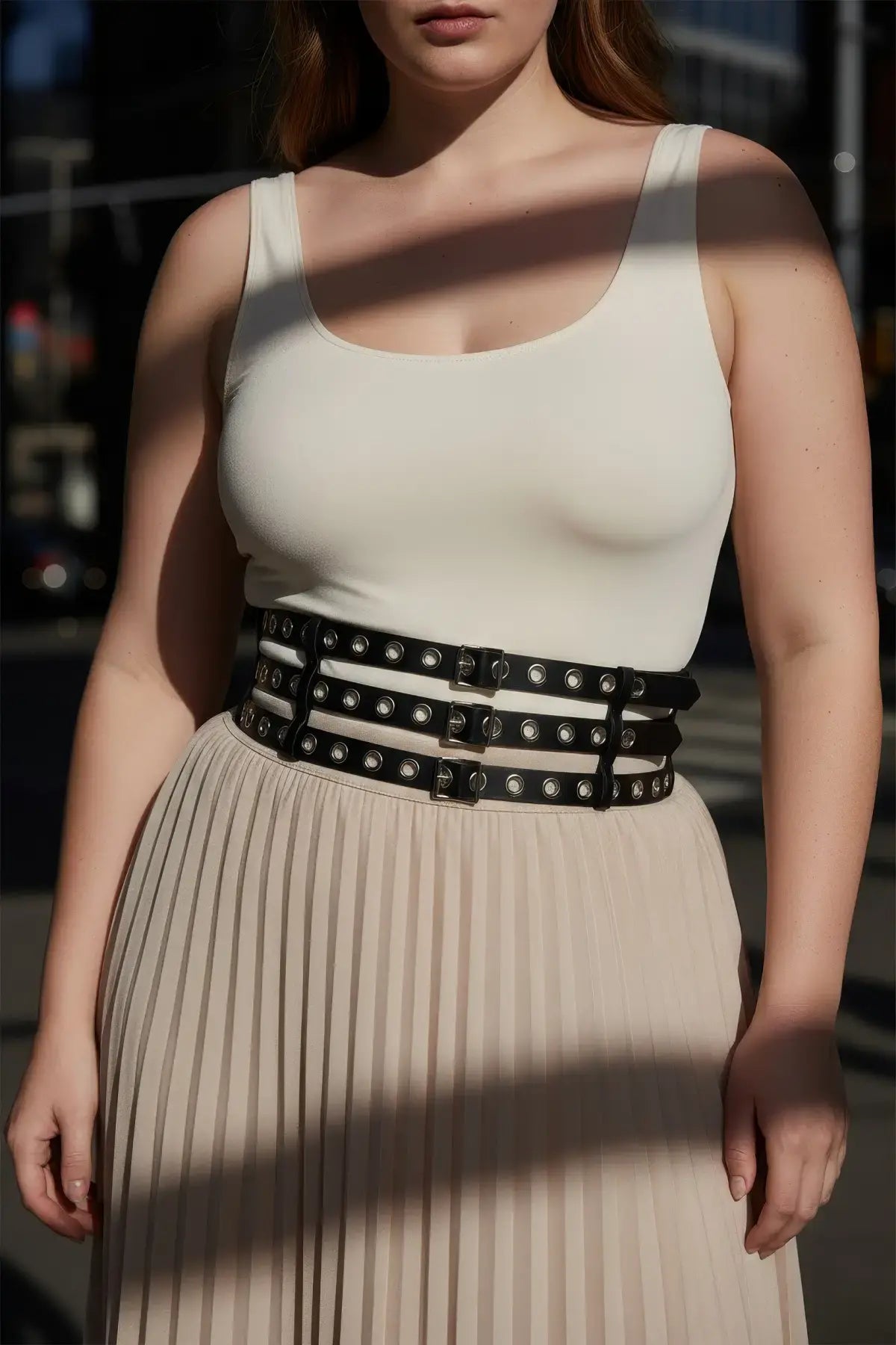 Plus-Size black vegan leather belt with double-row grommets and three buckles worn at waist by HarnessClub