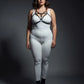 Plus size black elastic bralette harness with V-frame O-ring worn by a model in a white bodysuit.