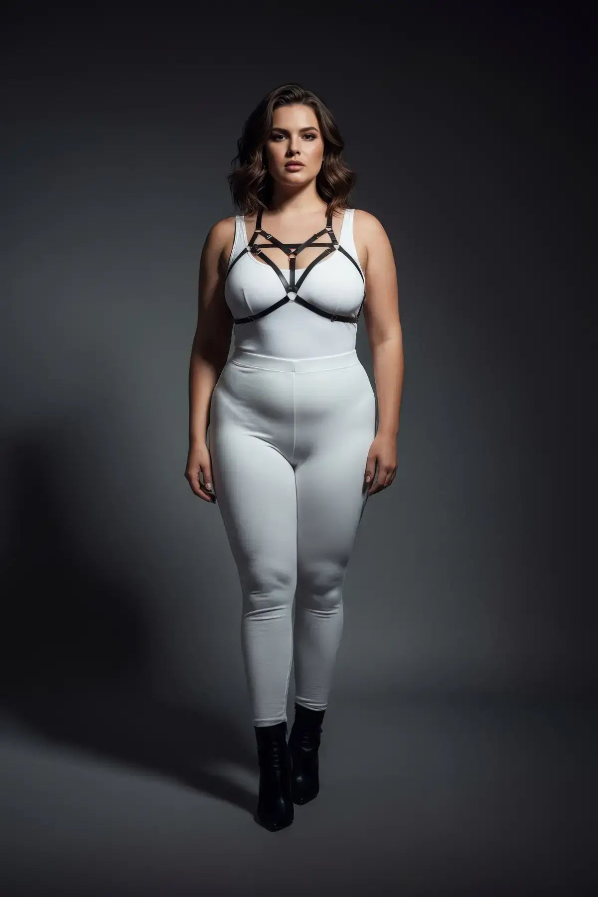 Plus size black elastic bralette harness with V-frame O-ring worn by a model in a white bodysuit.