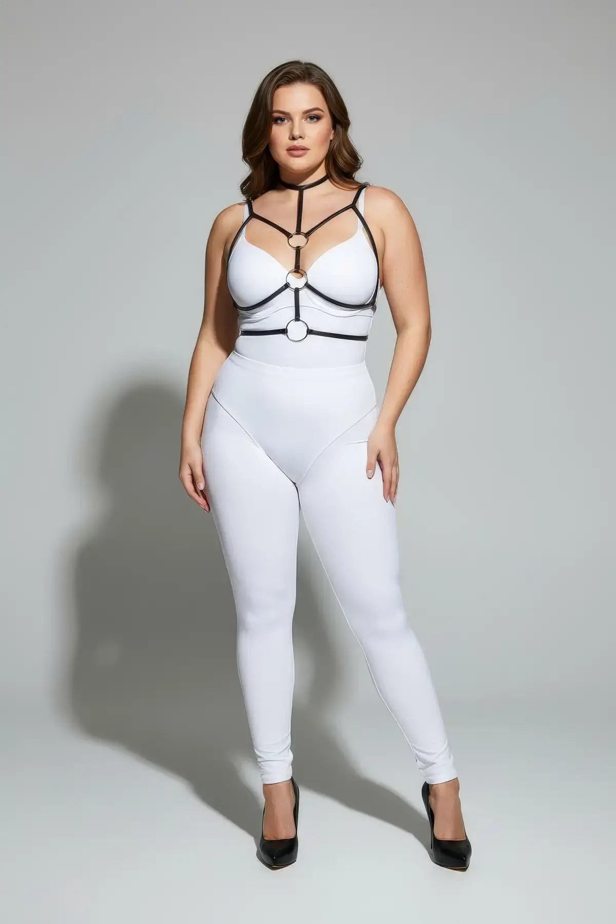 Plus-size black elastic collar and O-ring harness by HarnessClub worn over a white bodysuit