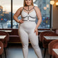 Plus-size black elastic collar and O-ring harness over a white bodysuit worn by a plus-size model