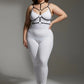 Plus size black elastic collar and O-ring harness by HarnessClub on model wearing white bodysuit