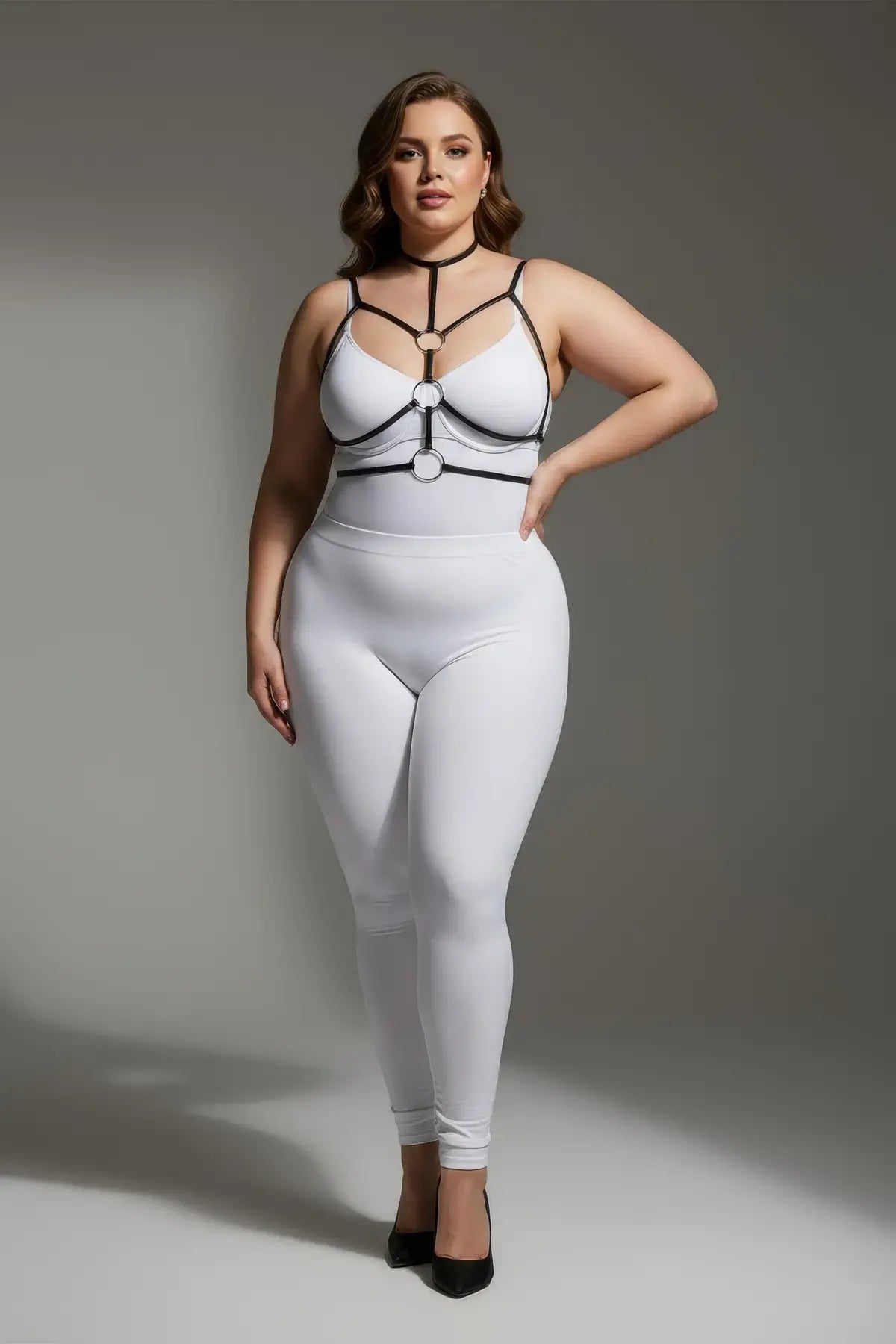 Plus size black elastic collar and O-ring harness by HarnessClub on model wearing white bodysuit