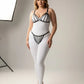 Plus Size Black Elastic Multi-Strap Fantasy Harness by HarnessClub worn over a white bodysuit