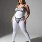 Plus-size black elastic multi-strap fantasy harness by HarnessClub, worn over a white bodysuit