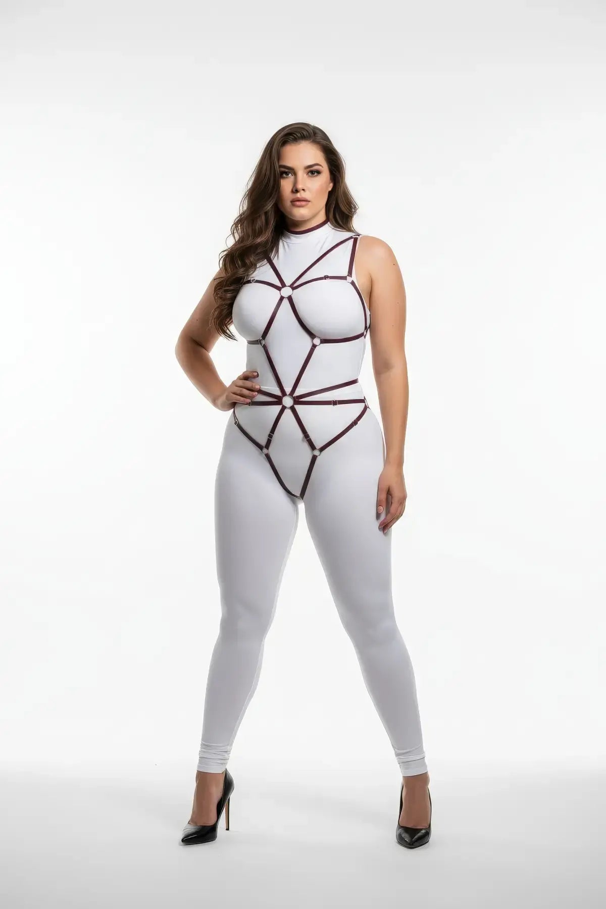 Plus-size black elastic O-ring web body harness on white bodysuit with geometric straps