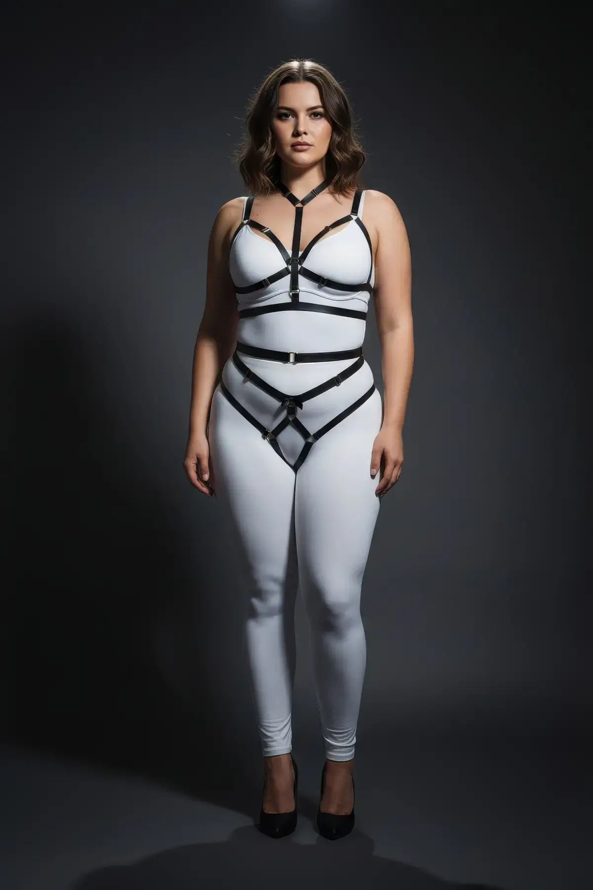 Plus size black elastic two-piece harness set for chest and hips, modeled over a white bodysuit.