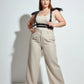 Plus-size black epaulette fringe shoulder harness in vegan leather by HarnessClub worn over beige ribbed tank