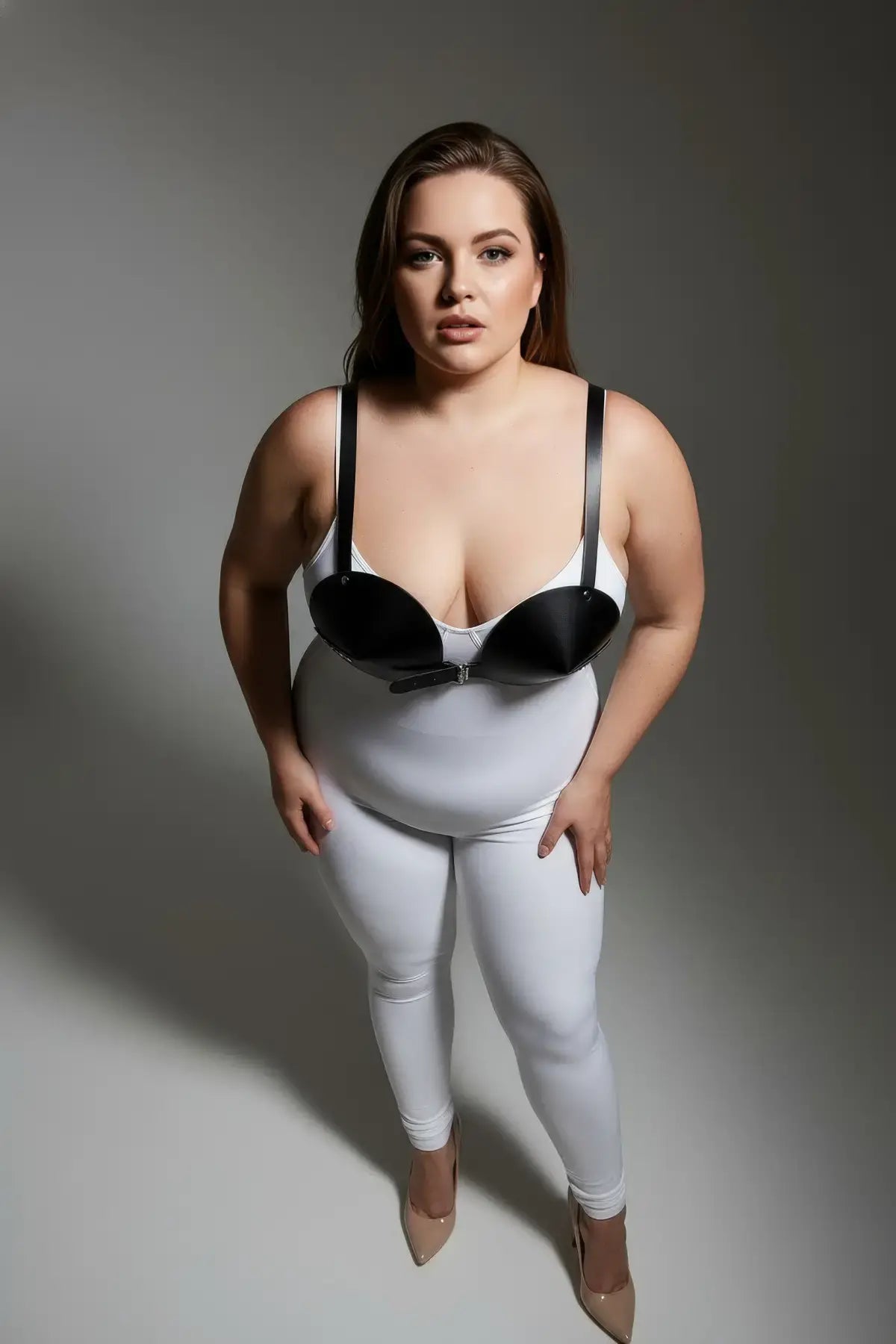Plus-size black faux-leather bustier body harness worn by a model