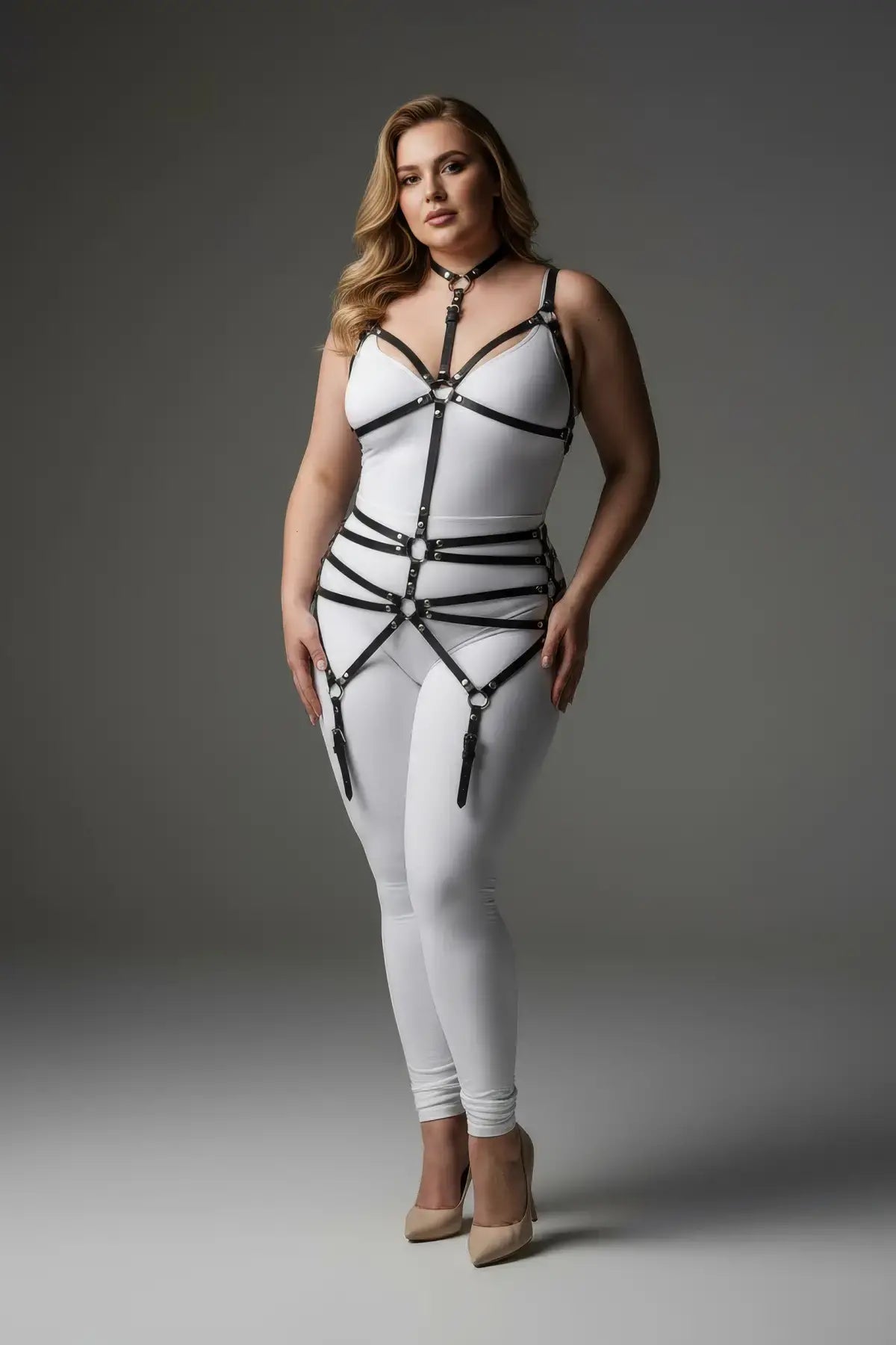 Plus-size white bustier harness bodysuit with black faux-leather straps and garters.
