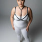 Plus Size Black Faux Leather Chest Harness worn over a white bodysuit by HarnessClub
