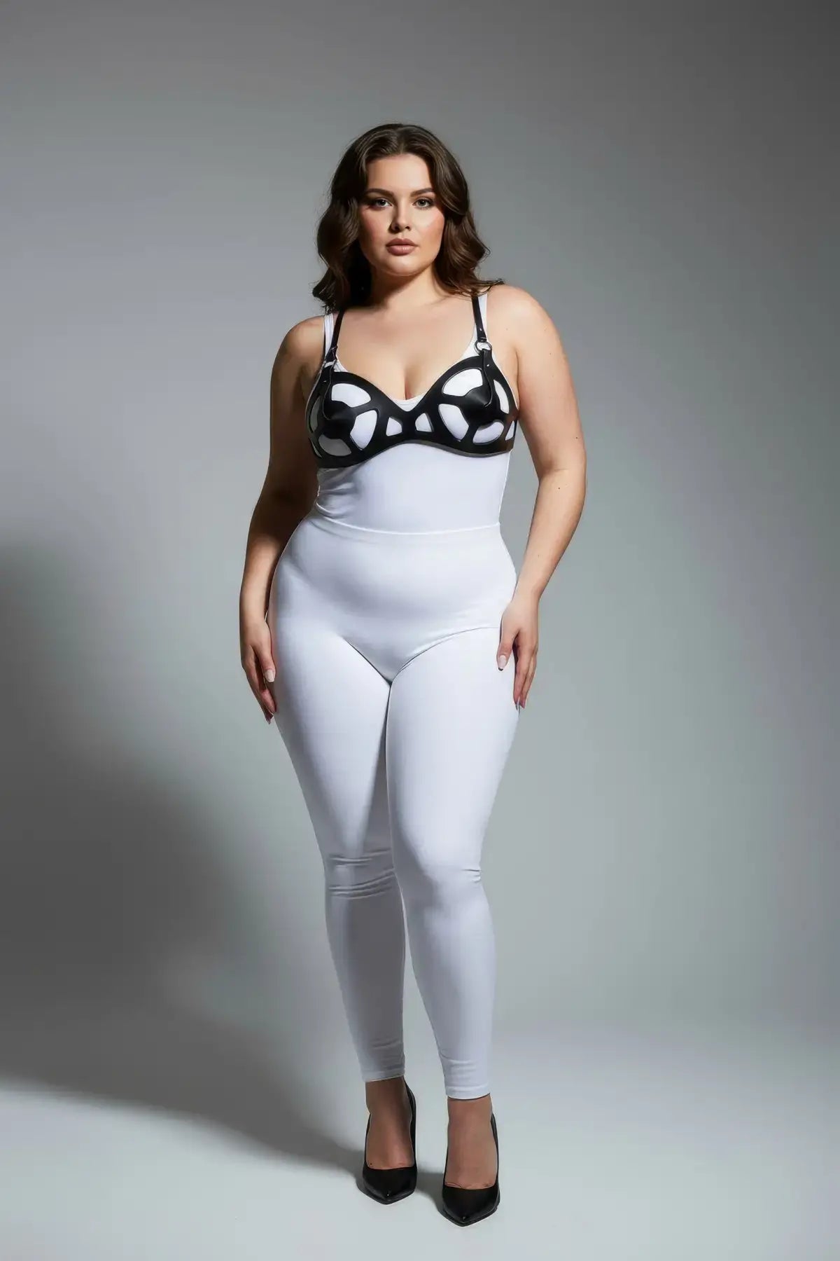 Plus-size black faux-leather fantasy body harness set modeled over a white bodysuit