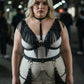 Plus-size black fringe vegan-leather body harness with studded choker and chain accents