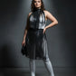 Plus-size black vegan-leather fringe capelet and belted long skirt set worn by model