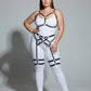 Plus-size white bodysuit with black faux-leather harness straps and garter harness