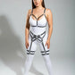 Plus-size white full-body bodysuit with black faux-leather harness, metal rings, and thigh garter straps.