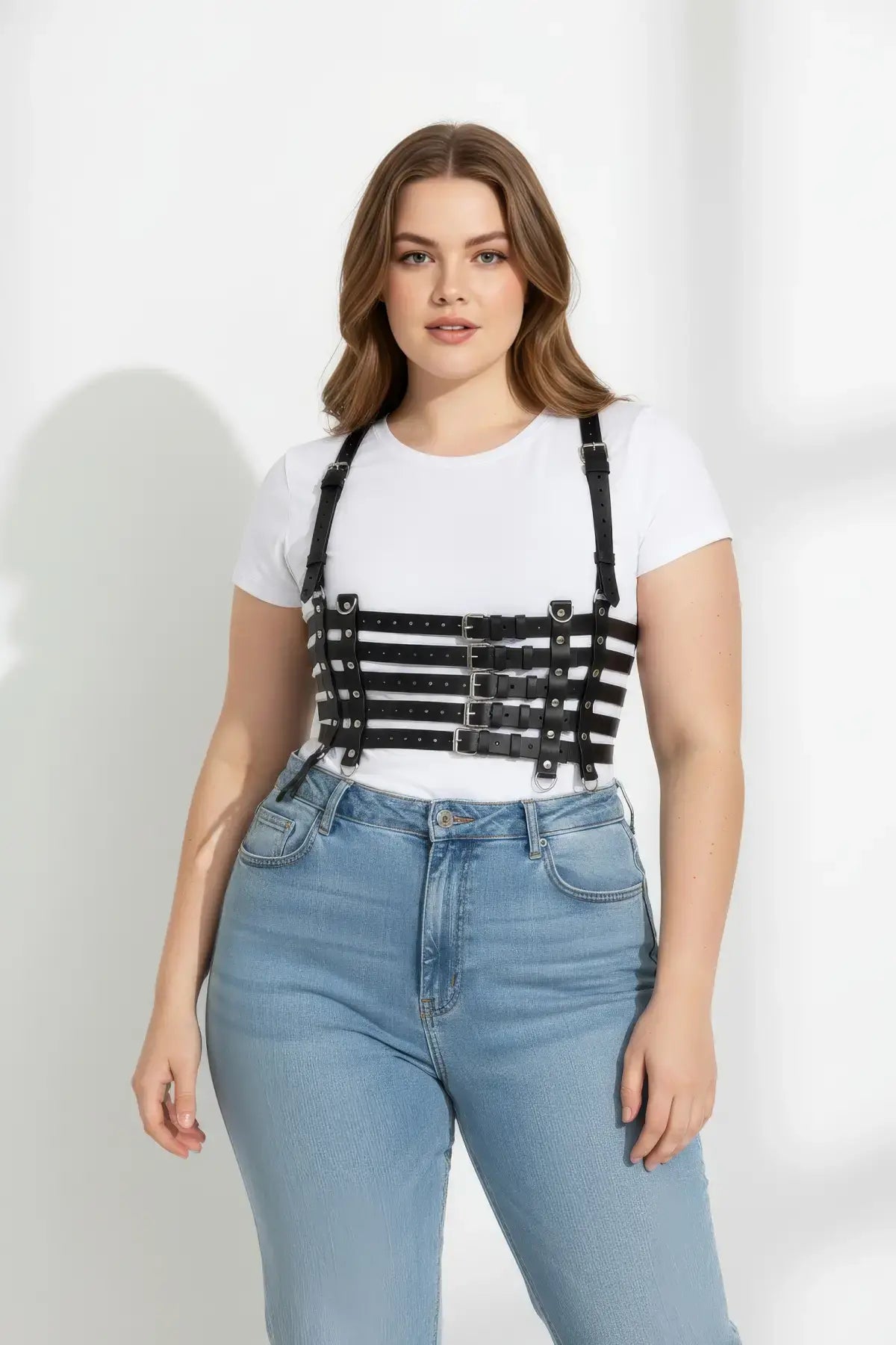 Plus Size Black vegan leather full-torso corset body harness by HarnessClub worn over a white tee and blue jeans