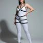 Plus-size black faux leather body harness by HarnessClub on white bodysuit, fully adjustable straps.