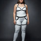 Plus-size black garter-frame full-body harness set worn over a white bodysuit.