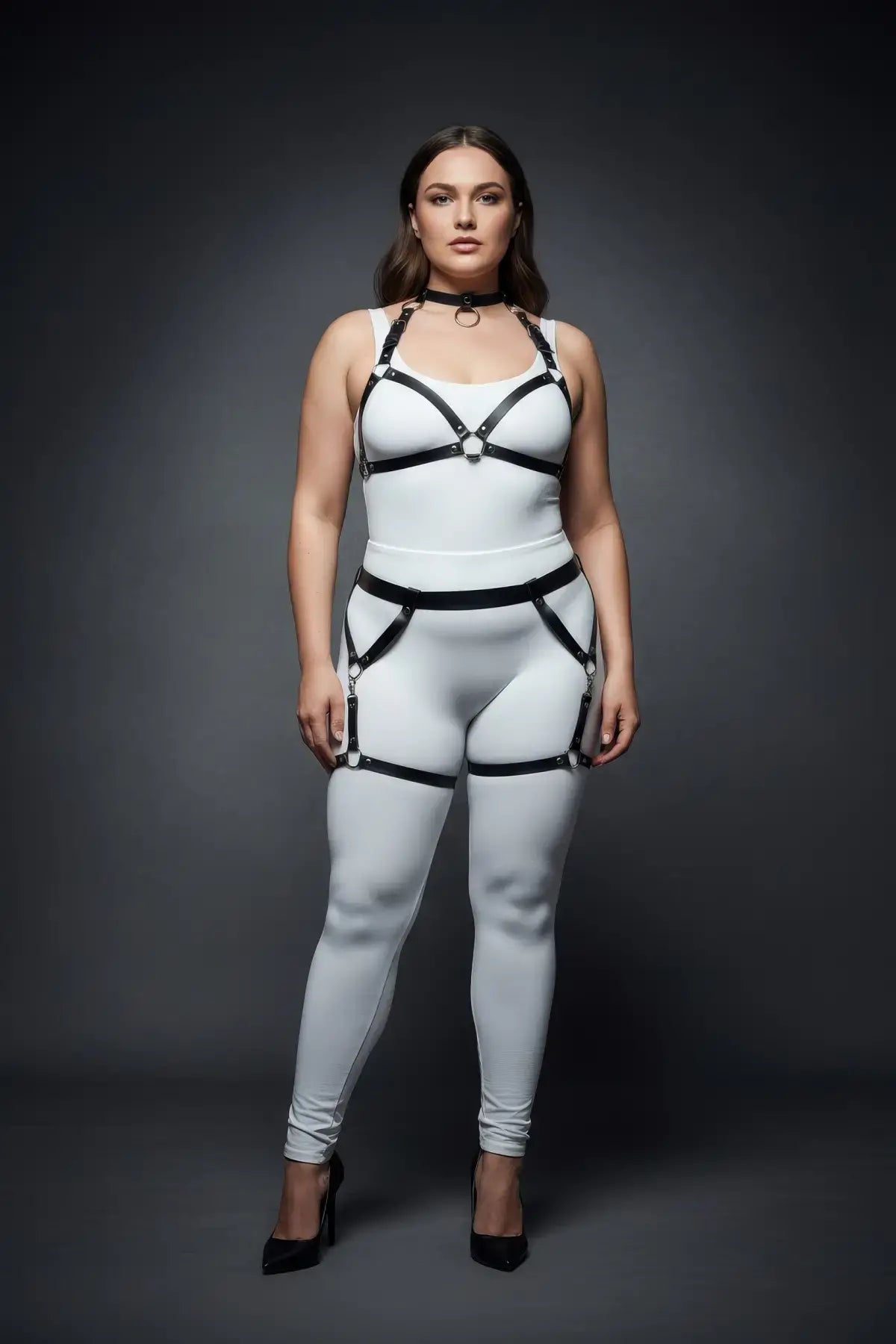 Plus-size black garter-frame full-body harness set worn over a white bodysuit.