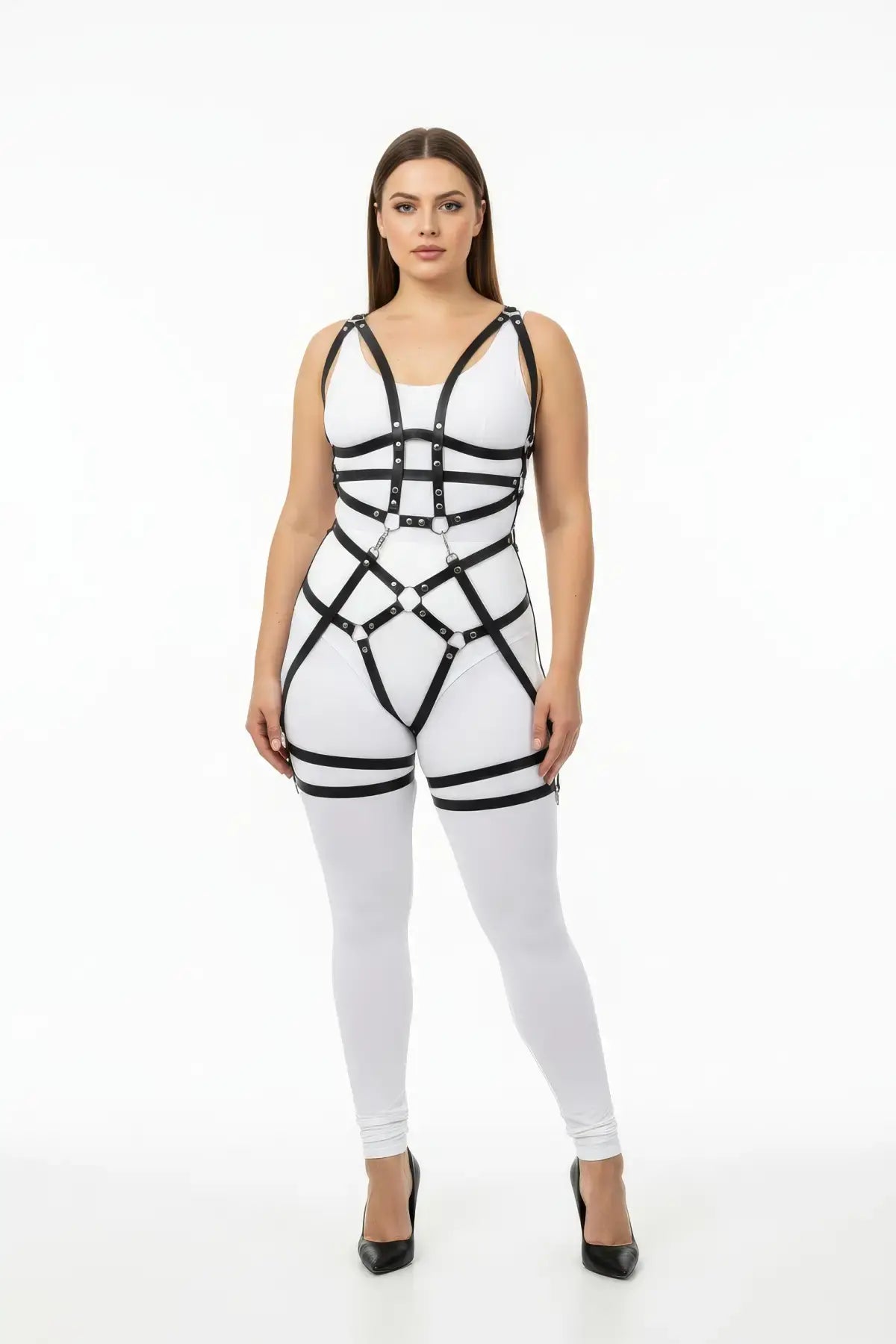 Plus-size black grid-band full-body harness; vegan leather with riveted straps worn over a white bodysuit