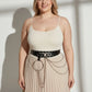 Plus-size black vegan-leather grommet belt with O-ring and chain detail at the waist over a cream top