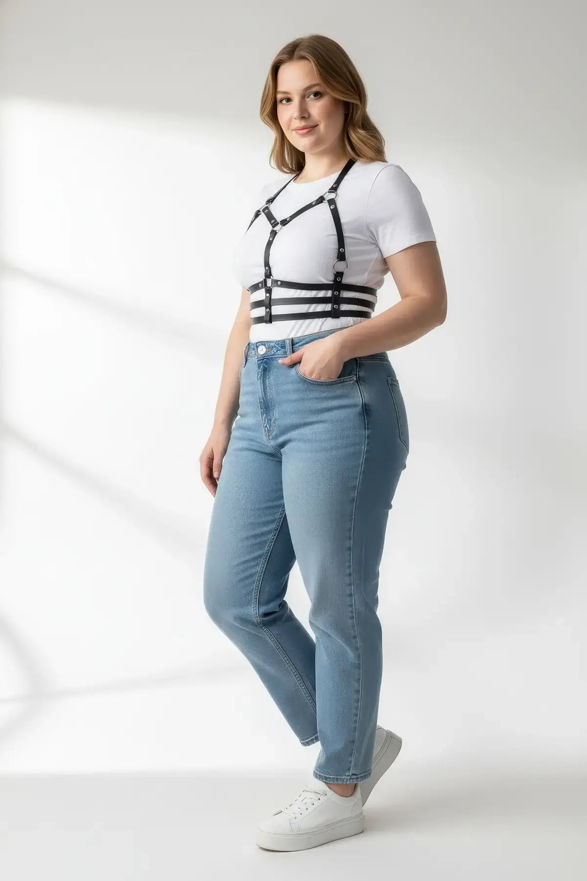 Plus-size black vegan leather halter chest harness with ribcage bands worn over a white tee.