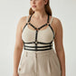 Plus-size black vegan leather halter chest harness with ribcage bands on model