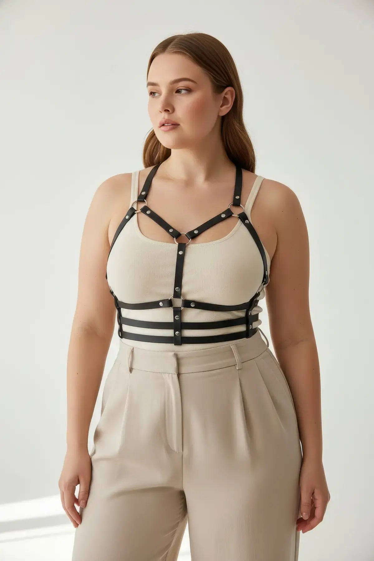 Plus-size black vegan leather halter chest harness with ribcage bands on model