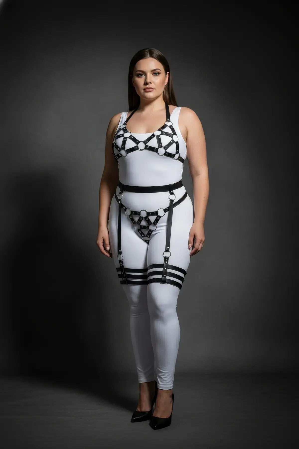 Plus Size Black Halterneck Cage and Multi-Band Thigh Harness Set in vegan leather worn over a white bodysuit.