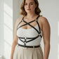 Plus-size black leather harness-style body accessory worn over white top