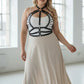 Plus-size black leather lace-up corset-style harness with riveted straps worn over a white top.
