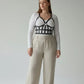 Plus Size Black Leather Body Harness Outfit Completer by HarnessClub worn over a white top.