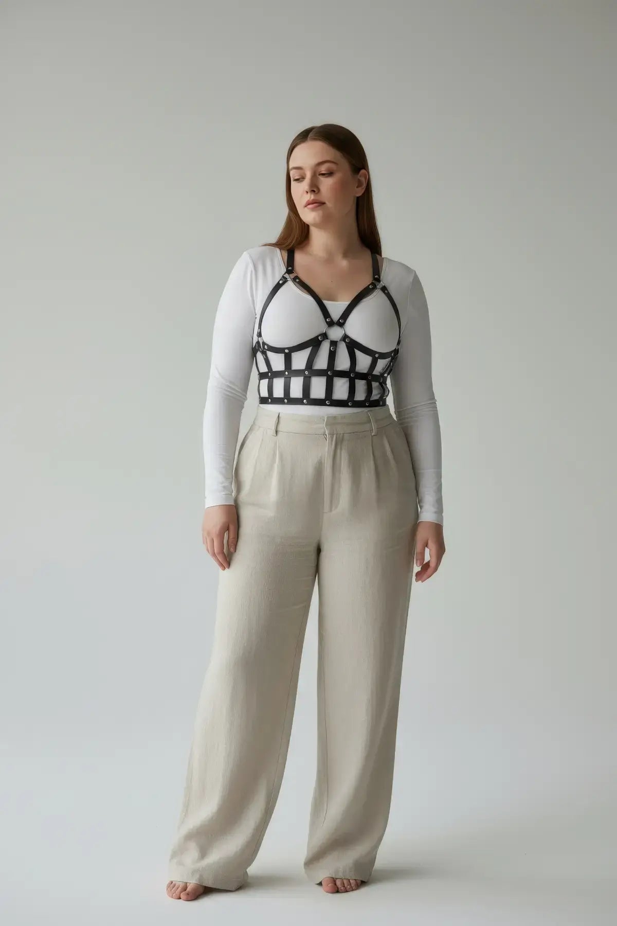 Plus Size Black Leather Body Harness Outfit Completer by HarnessClub worn over a white top.