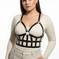 Plus size black leather body harness outfit completer by HarnessClub with a strappy design worn over a beige top