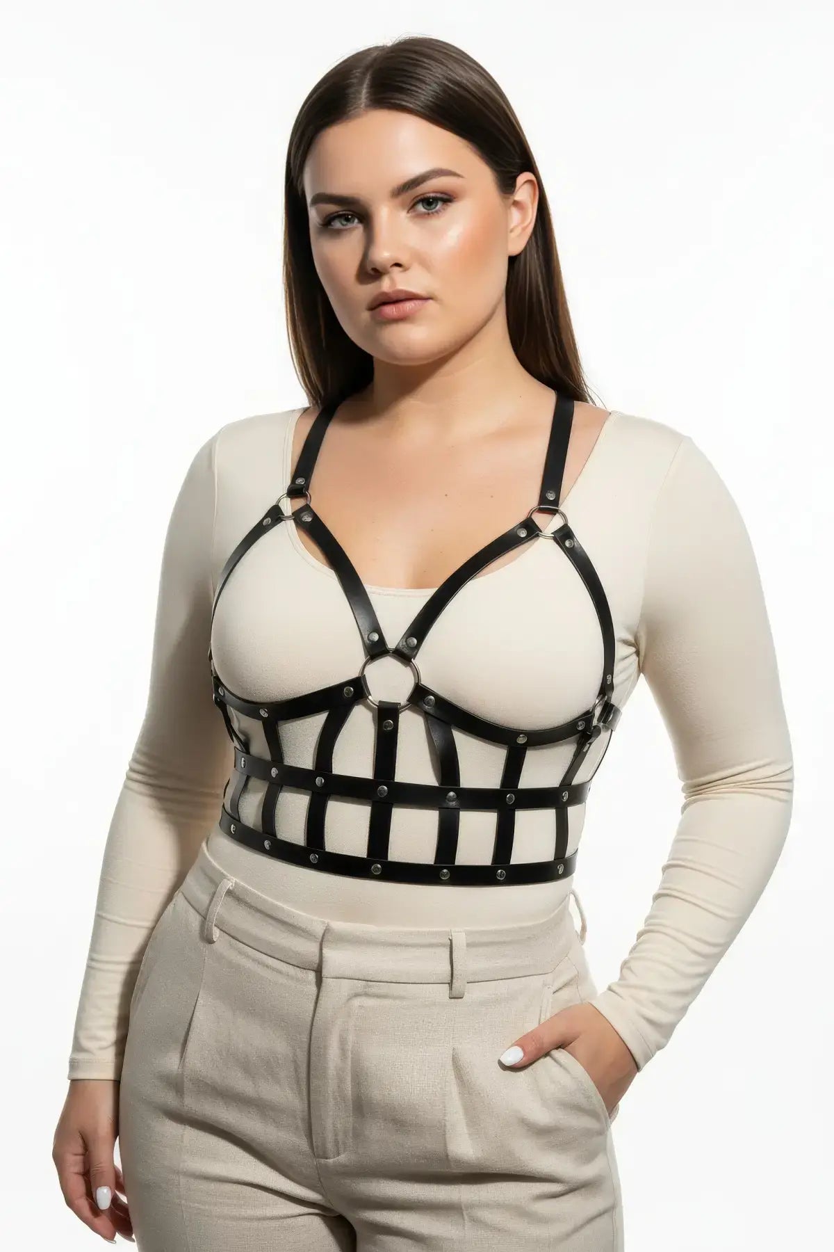 Plus size black leather body harness outfit completer by HarnessClub with a strappy design worn over a beige top