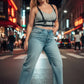 Plus Size Black Leather Harness-Look Adjustable Body Accessory by HarnessClub worn over a gray tank, paired with blue jeans