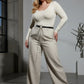 HarnessClub Plus Size Black Leather Multi-Chain Detail Belt worn at the waist with silver chain drape over light pants.