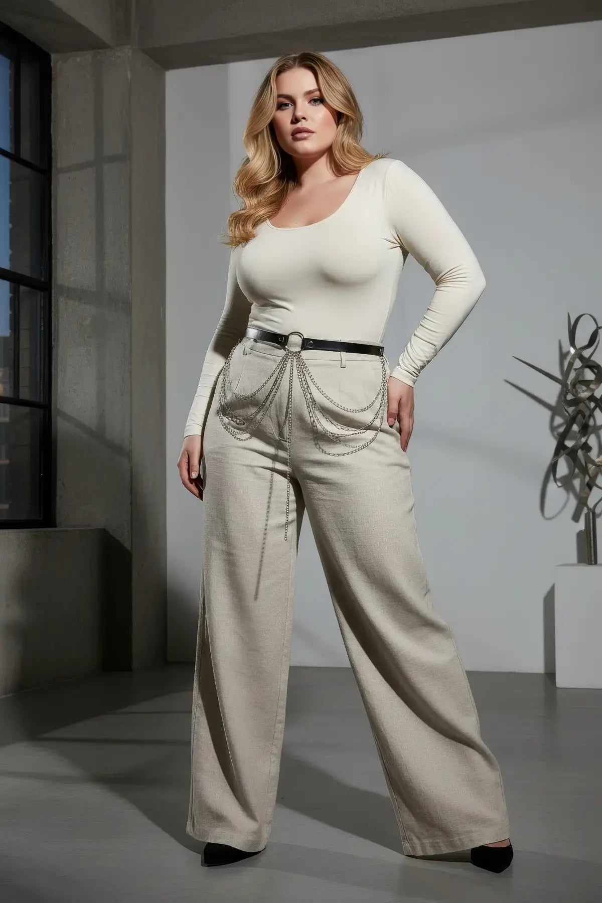 HarnessClub Plus Size Black Leather Multi-Chain Detail Belt worn at the waist with silver chain drape over light pants.