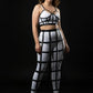 Plus-size black vegan-leather long cage skirt and chest harness set (two-piece) shown on model.