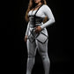 Plus-size black vegan-leather corset harness with cage skirt straps worn over a white bodysuit