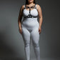 Plus-size black vegan-leather multi-band O-ring cage chest harness worn over a white bodysuit