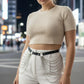 Plus Size black vegan leather multi-drape chain belt worn at the waist over white pants