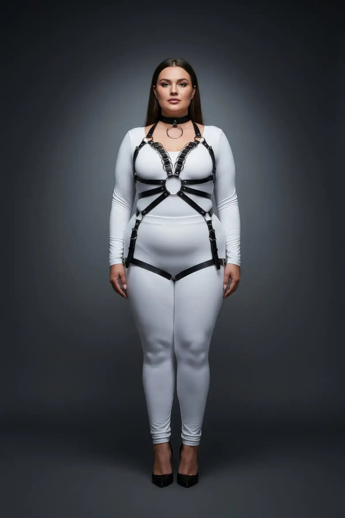 Plus-size black vegan-leather O-ring chain-detail body harness by HarnessClub on model