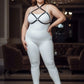 Plus-size black faux-leather O-ring chest harness over white bodysuit