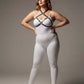 Plus-size black O-ring faux leather chest harness by HarnessClub worn over a white bodysuit