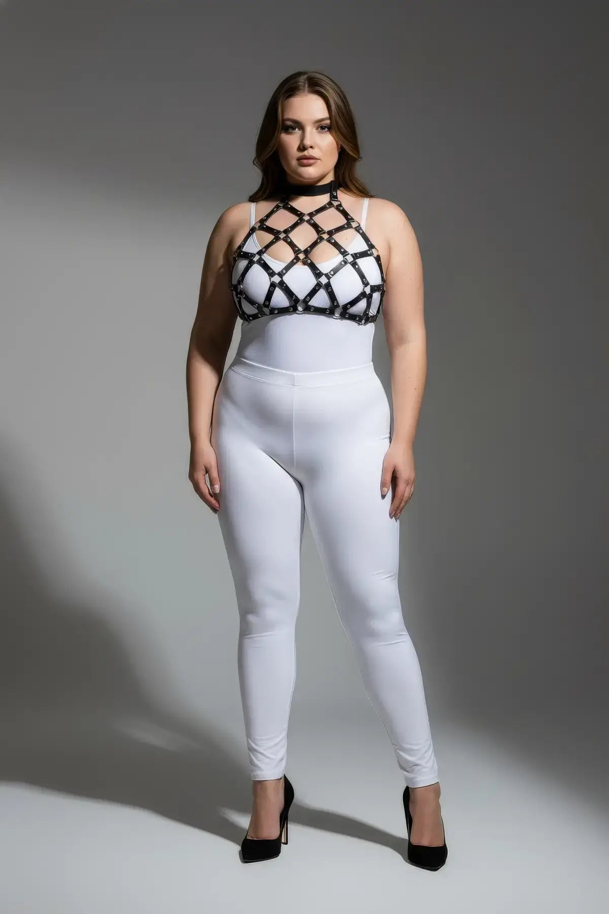 Plus Size Black O-Ring Faux Leather Chest Harness with lattice straps worn over white bodysuit