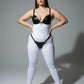 Plus-size black faux-leather O-ring harness set with studded bra top and matching waist belt