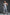 Plus-size black faux-leather O-ring harness worn over a white bodysuit; body accessory