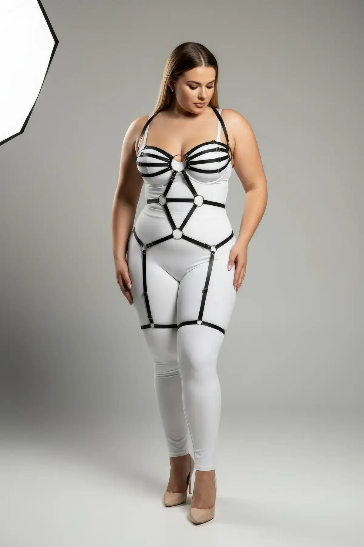 Plus-size black O-ring full-body faux leather garter harness over white bodysuit, HarnessClub